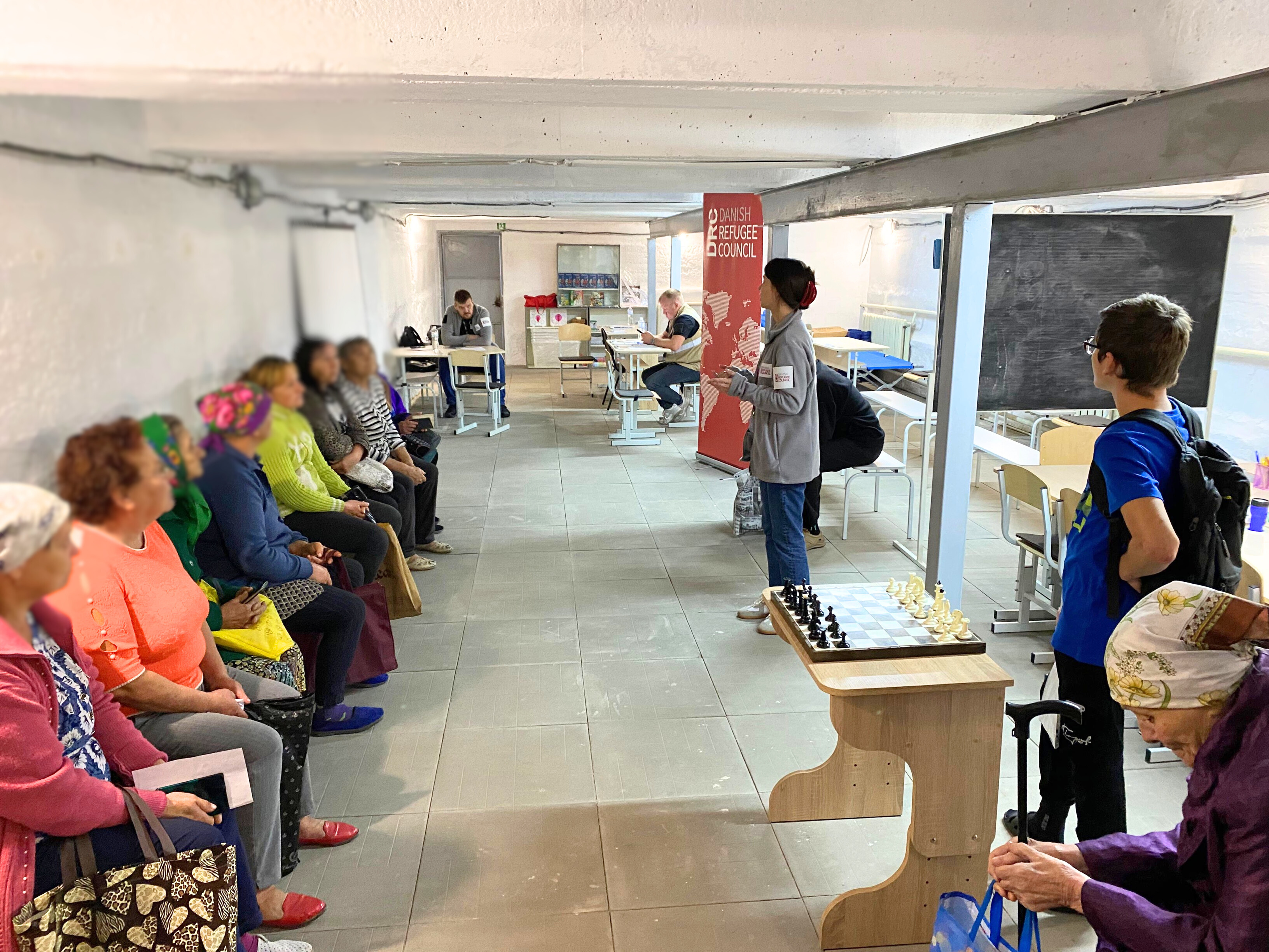 Registration for cash support in an underground shelter in Bereza village. ©DRC Ukraine, Sumy Oblast, 2024